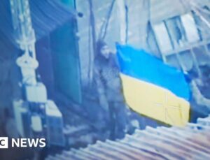 Ukrainians raise flag to show BBC the fight goes on in city claimed by Russia