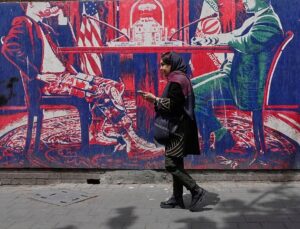 Iranians at home divided between hope for regime change and war fears